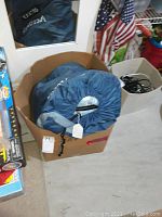 Blue aerobed deflated and packed in blue cover inside a cardboard box