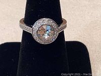 Front view of the Swarovski ring showing the central 7mm round crystal and surrounding smaller crystals on silver rhodium plated band.