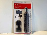 Front view of Joby GripTight ONE GP Stand in original packaging with tripod and mount visible.