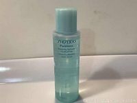 Front view of the semi-transparent light blue plastic bottle with product label visible