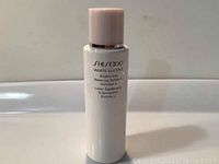 Front view of white cylindrical bottle with light pink cap showing Shiseido White Lucent Brightening Balancing Softener Enriched labelling.