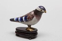 Side view of Chinese cloisonné bird figurine on wooden footed base
