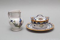 Photo of lidded serving bowl with attached plate and creamer jug shown side-by-side.