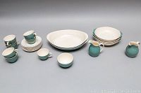 Full set photo showing teacups, saucers, cereal bowls, vegetable serving bowls, creamer, milker, and sugar bowl arranged side by side.