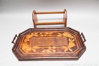 Detailed angled view of the tray emphasizing the floral pyrography and handle design.