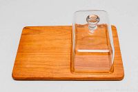 Full view of teak wood cheese tray base with clear glass lid in place, showing overall design and materials.
