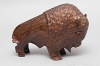 Side view of dark brown rosewood buffalo sculpture showing detailed fur texture carving