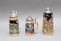Front view of 3 Western Germany beer steins with colorful relief scenes and metal lids