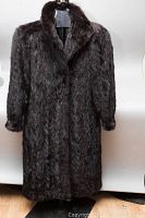 Full front view of coat on mannequin against neutral background
