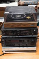 Stack of stereo components showing Lloyds turntable on top, two Sony black units underneath, and white Sony DVD-VHS player at bottom.