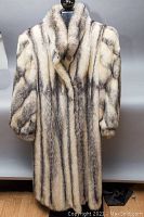 Front view of full-length coat on mannequin, showing shawl collar and vertical stripe pattern