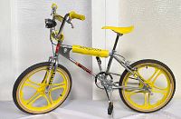 Full left-side profile showing entire bike frame, wheels, and accessories