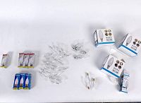 Wide view of all chandelier bulbs spread out on white surface showing boxed and loose bulbs