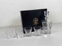 Full set showing whiskey decanter, four glasses, and black gift box
