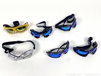 Five pairs of smaller ski goggles with varying lens colors and frame styles