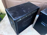 Top front angled view of one black Marshall amplifier showing control panel and Marshall logo.