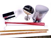 Full lot including mirror box organizer, round bathroom trash can, painted red baseball bat, and two vintage yardsticks.