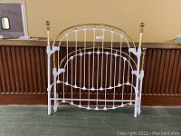 Front view of the brass and cast iron double size headboard.