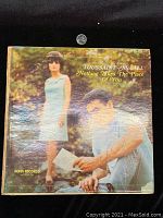 Front cover of Toussaint McCall LP showing the album title and Ronn Records logo, with a quarter placed above for size reference.