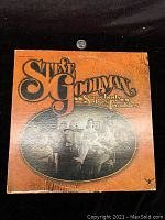 Front cover of Steven Goodman LP Somebody Elses Troubles showing artist and album title with an oval black and white photo of people at a table.