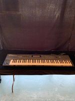 Front view of entire Roland D-70 synthesizer on table