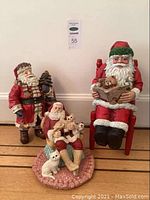 Photo of all three Santa Claus figurines together showing size and detail