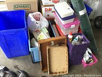 View of various storage containers, bins, trays, and bottles grouped together, showing condition, colors, and types of items included in the lot.