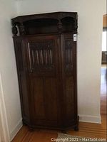 Front view of dark stained wood cupboard