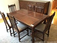 Angled view of table and six chairs against sideboard