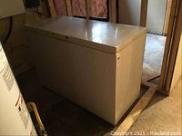 Closed Kenmore chest freezer showing white exterior and size