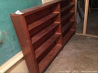 Front corner view showing the double bookshelf unit made of wood with four shelves each