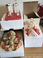 Wide view of Cherished Teddies Christmas bears in original styrofoam packaging and boxes, one bear on the right showing musical mechanism.