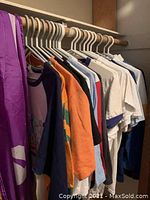 Hanging lot overview showing multiple vintage T-shirts of various colors