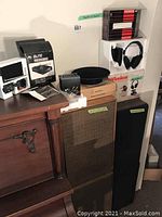 Photo showing assortment of stereo and audio equipment including speakers, headphones, video sender, and amplifier boxes.