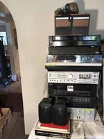 Overall stack of components: VHS player, turntable, cassette deck, receivers, speakers, headphones.