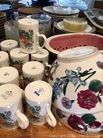 Royal Kingston mugs arranged with various bowls and plates in background