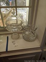 Photo showing covered footed dish, sugar and creamer, and glass ice bucket with tongs