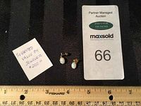 Photo showing pair of small opal earrings next to a ruler for size reference and auction tags.