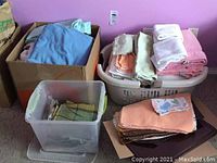 Box with folded cotton sheets and towels