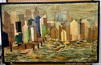 Front view of decoupage artwork showing harbor boats and city skyline in collage style within black frame