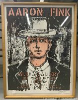 Full front view of framed silkscreen print showing portrait, text and wooden frame