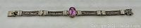 Full length top view of the sterling silver Byzantine chain bracelet with pink stone, laid flat to show entire piece.