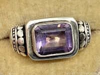 Close front view showing emerald cut amethyst set in wide sterling silver band with bead detail