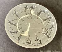 Top-down view of the circular dish with relief decoration of dancing female figures around the rim.