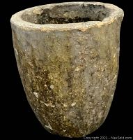 Front angle view of the heavy, cylindrical stoneware smelting pot showing rough surface and worn glaze.