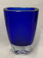 Front view of the cobalt blue vase showing the color, shape, and clear bottom portion.