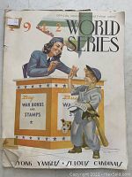 Front cover of 1942 World Series official program featuring wartime themed illustration promoting war bonds and stamps.