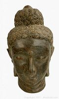 Front view of terracotta Buddha head against white background