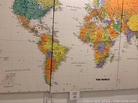 Close-up photo of the central section of the world map showing continents of North and South America, Atlantic Ocean and part of Africa and Europe.