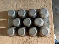 Top view showing 10 cup molds labeled with brand and model details.